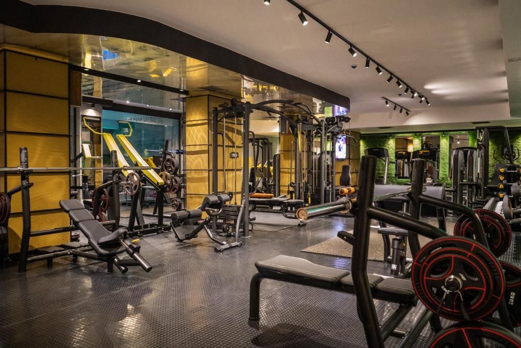 A gym with various exercise equipment, including weight machines and free weights.