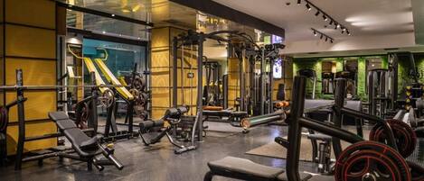 A gym with various exercise equipment, including weight machines and free weights.