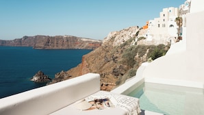 A white building with a pool, overlooking a rocky coastline and the sea. - Armenaki -  Adults Only (Santorini)