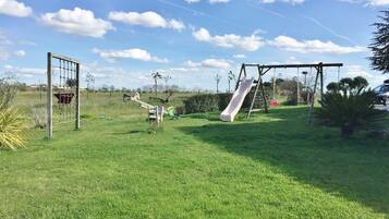 Children can play freely in this outdoor space with a slide and swings.