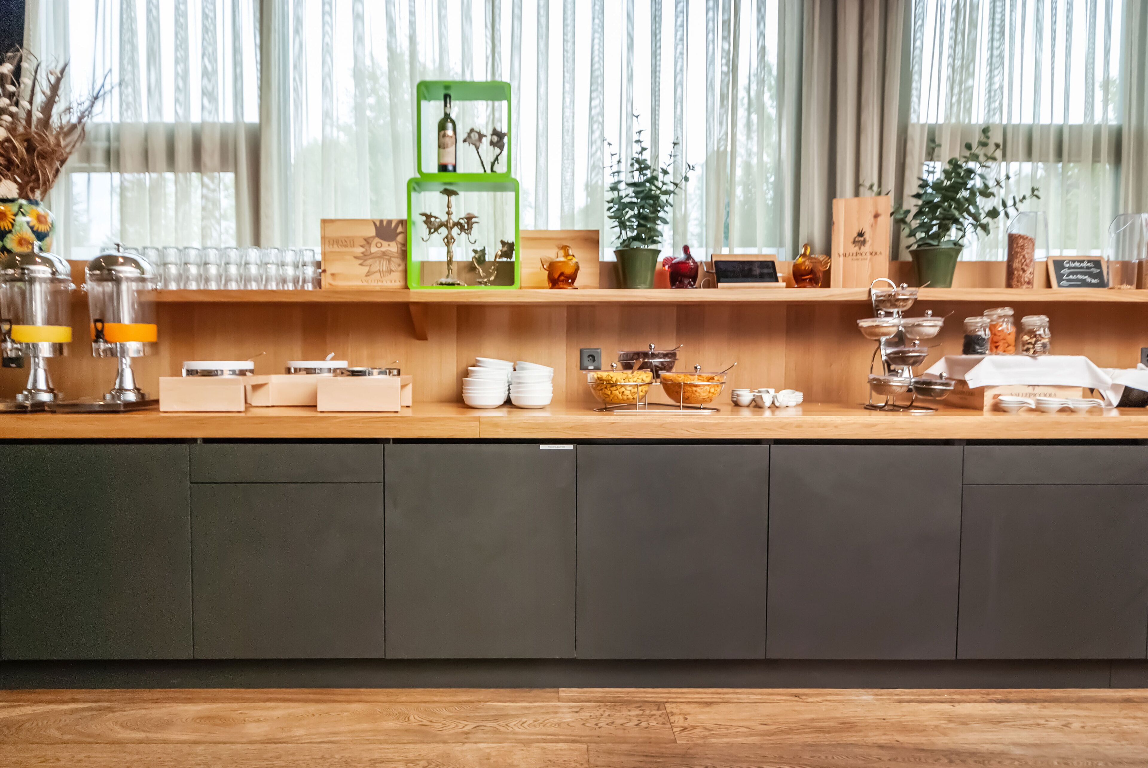 A kitchen counter with various items including a coffee machine, jars, and decorative objects.