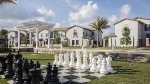 A residential area with a large chessboard set up on the lawn. - 3BR Home Near Legoland & Disney | Pool, Game Room, Balmoral Resort Amenities | Pet-Friendly (Haines City)