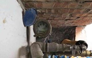 A brick wall with a gauge and a pipe, possibly part of a building's infrastructure. - 4 Star Holiday Home in Lemvig (Lemvig)