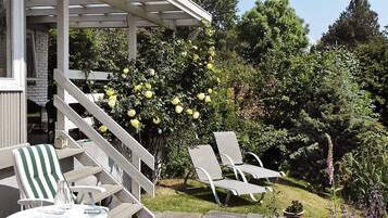 A patio area with outdoor seating and a pergola structure.
