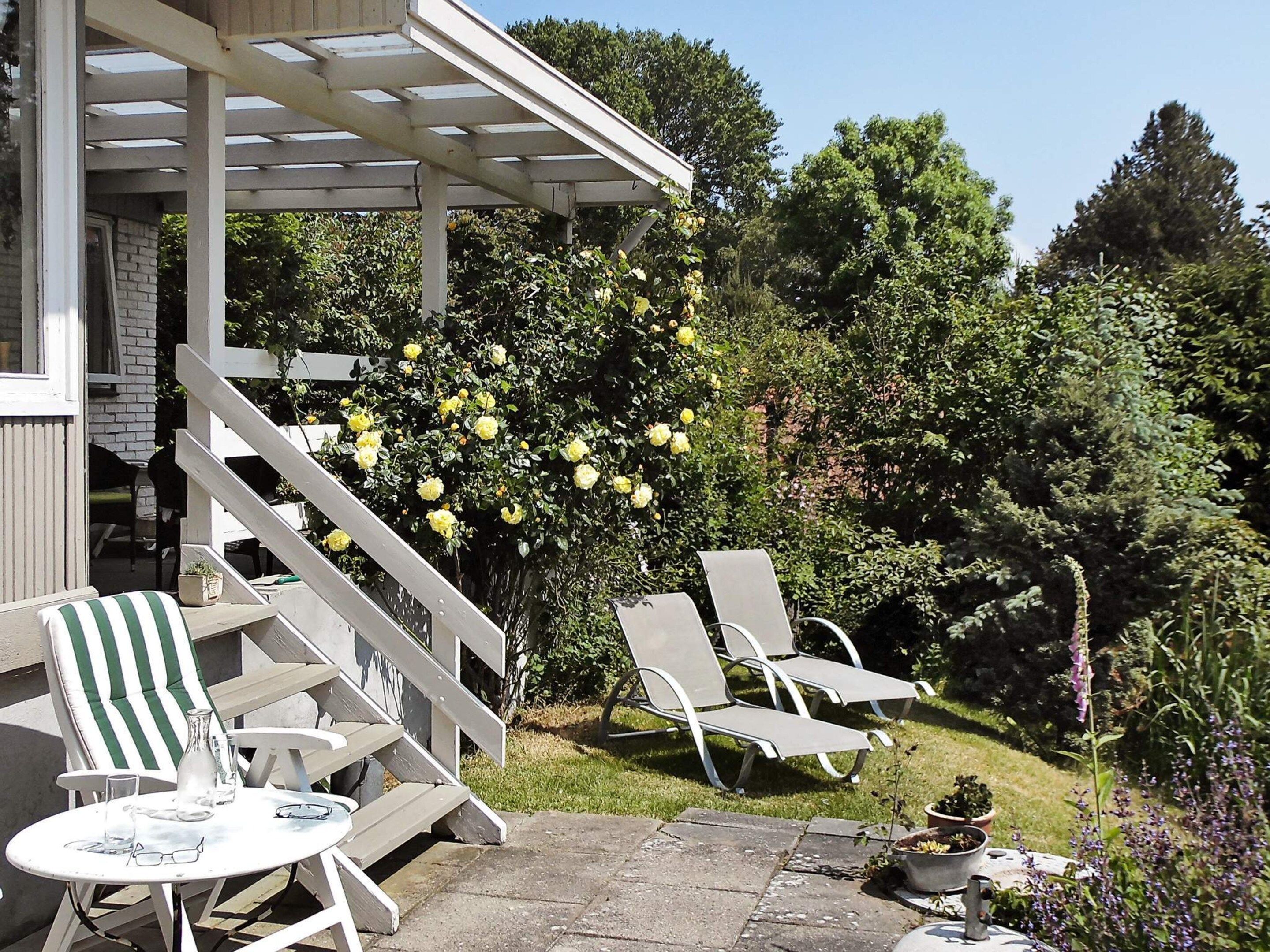 A patio area with outdoor seating and a pergola structure.