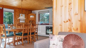 A wooden interior with a dining area, kitchen, and living space. - 4 Person Holiday Home in Ulfborg (Ulfborg)