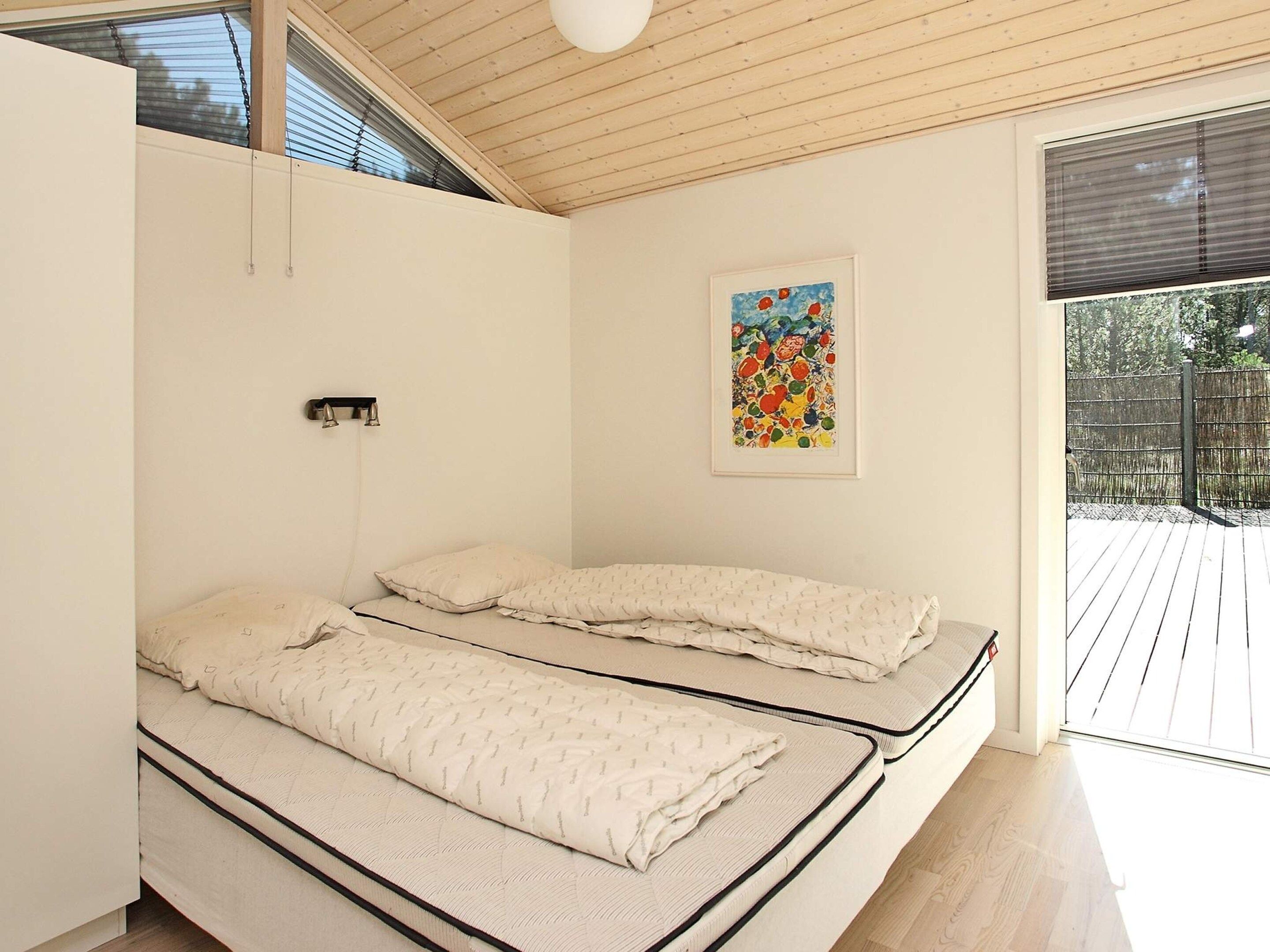 A room with a bed, a window, and a door.