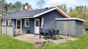 A single-story house with a covered patio, a dining area, and a garage. - Secluded Holiday Home in Jutland near Beach (Hals)