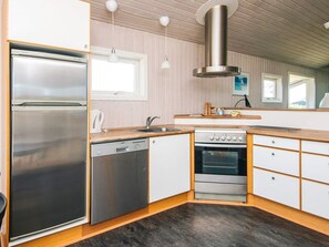 A modern kitchen with stainless steel appliances, a dishwasher, and a built-in oven.