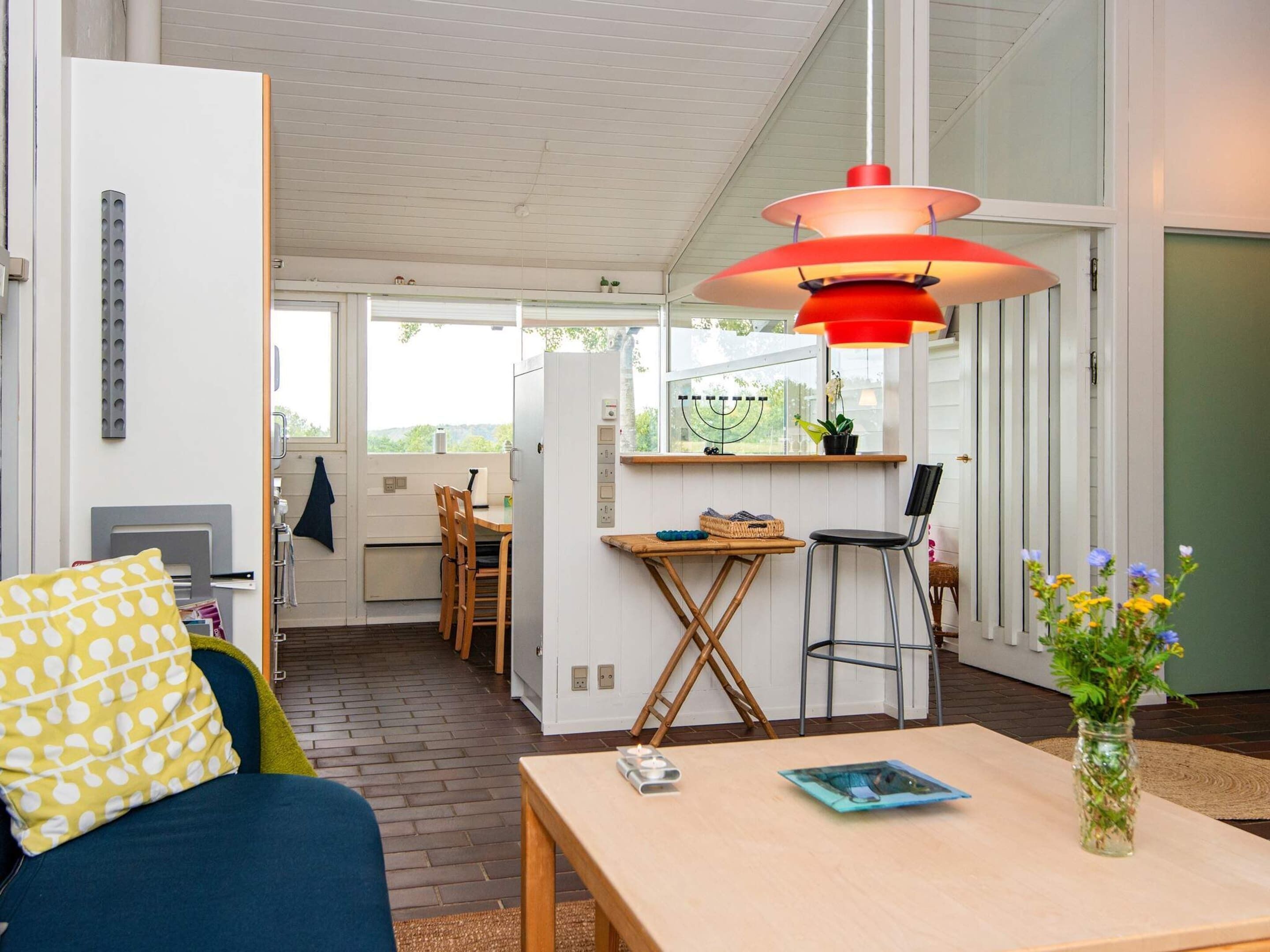A compact living space with a dining area, a kitchen, and a seating area with a table and chairs.