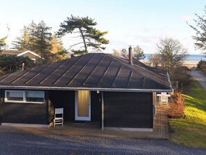 A single-story building with a sloped roof, a front door, and a small porch area. - 5 Star Holiday Home in Hals (Hals)