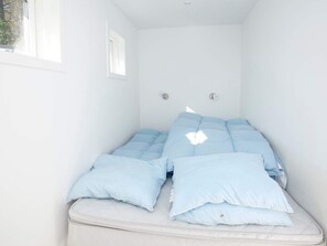A room with a bed, a window, and a wall-mounted light fixture. - 5 Star Holiday Home in Hals (Hals)