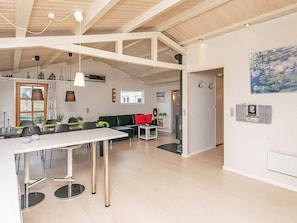 A modern interior with a dining area, kitchen, and living space. - 6 Person Holiday Home in Frorup (Frørup)
