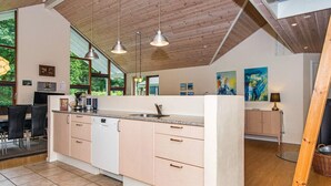 A modern kitchen with a central island, pendant lighting, and large windows. - 4 Star Holiday Home in Aabenraa (Aabenraa)