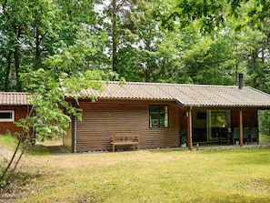 A rustic cabin with a wooden exterior, a porch, and a bench. - 6 Person Holiday Home in Ronne (Ronne)