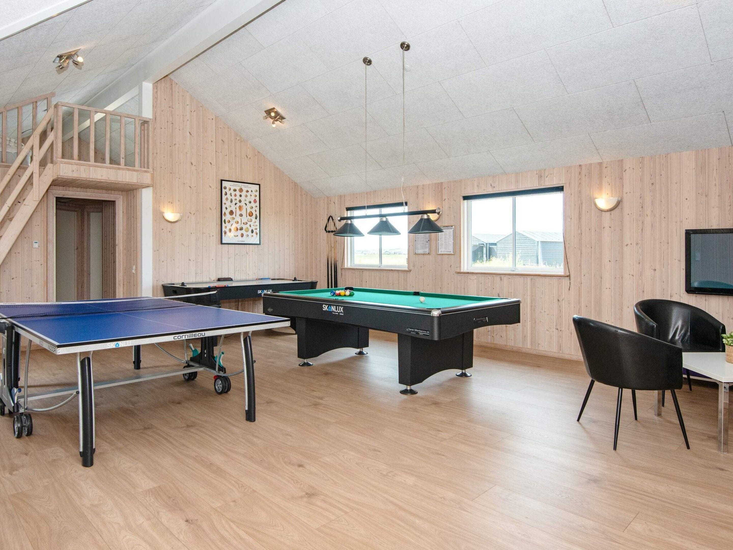Et aktivitetsrum med pingpongbord, billardbord og poolbord.