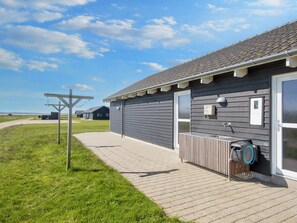 A building with a paved walkway, a door, and a window. - 5 Star Holiday Home in Harboore (Harboore)
