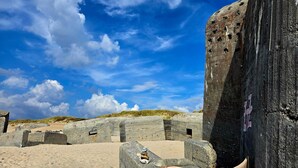 A beach with large concrete structures and a clear blue sky. - 8 Person Holiday Home in Ulfborg-by Traum (Ulfborg)