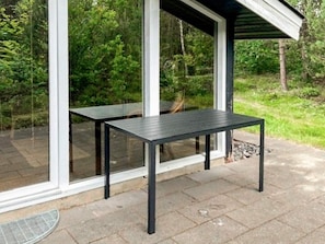 A patio with a table and a covered seating area. - 5 Person Holiday Home in Herning (Herning)
