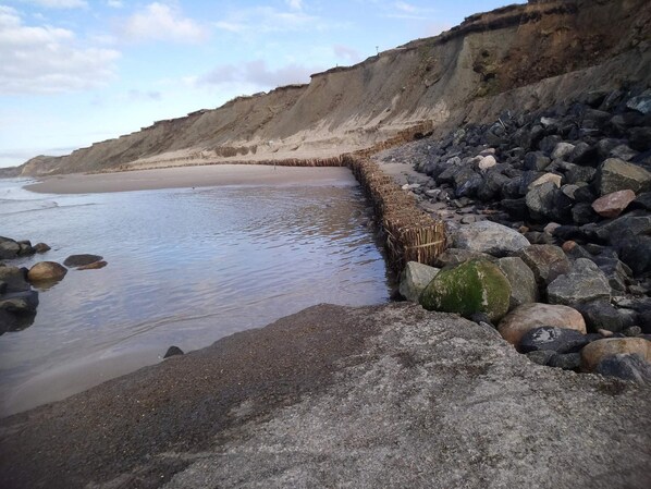 A rocky beach with a clear sky.