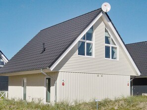 A single-story building with a gabled roof, a satellite dish, and a small porch area. - Holiday Home in Wendtorf (Wendtorf)