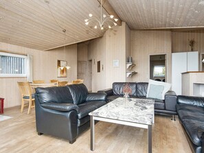 A modern living room with a black leather sofa, a marble coffee table, and a wooden ceiling. - 6 Person Holiday Home in Harboore (Harboore)