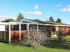 A single-story wooden house with a fenced backyard, a small porch, and a sloped roof. - Peaceful Holiday Home in Falster near Sea (Vaeggerlose)
