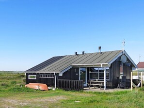A black building with a sloped roof, a visible number '48', and a picnic table outside. - 6 Person Holiday Home in Lemvig (Lemvig)