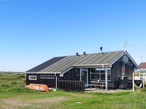 A black building with a sloped roof, a visible number '48', and a picnic table outside. - 6 Person Holiday Home in Lemvig (Lemvig)