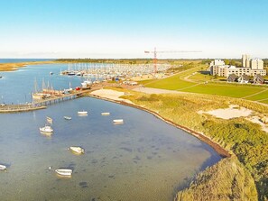 A marina with boats docked, a pier, and buildings in the background. - Holiday Home in Wendtorf (Wendtorf)