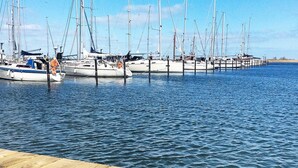 A marina with multiple sailboats docked at wooden piers. - Holiday Home in Wendtorf (Wendtorf)