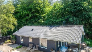 Ein zweistöckiges Haus mit überdachter Terrasse.