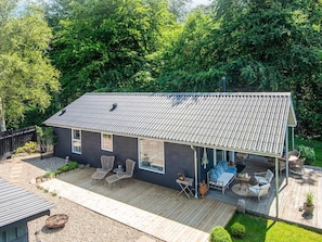 A two-story house with a covered patio area.