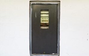 A door with a window, a metal frame, and a small latch at the bottom. - 4 Star Holiday Home in Struer (Struer)