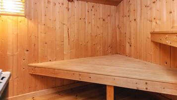 A wooden room with a large table and a bench.