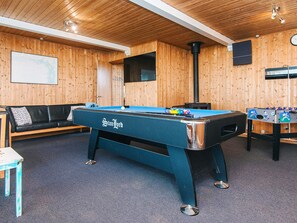 A pool table with a black cloth and "Stan Lord" branding, a sofa, a foosball table, and wooden paneling on the walls. - Vintage Holiday Home in Harboøre with Hot Tub (Harboore)