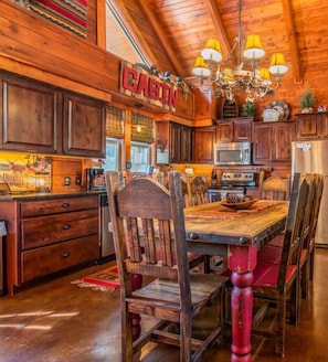 Enjoy cooking in this well-equipped kitchen with a central island, dining table, and modern appliances.