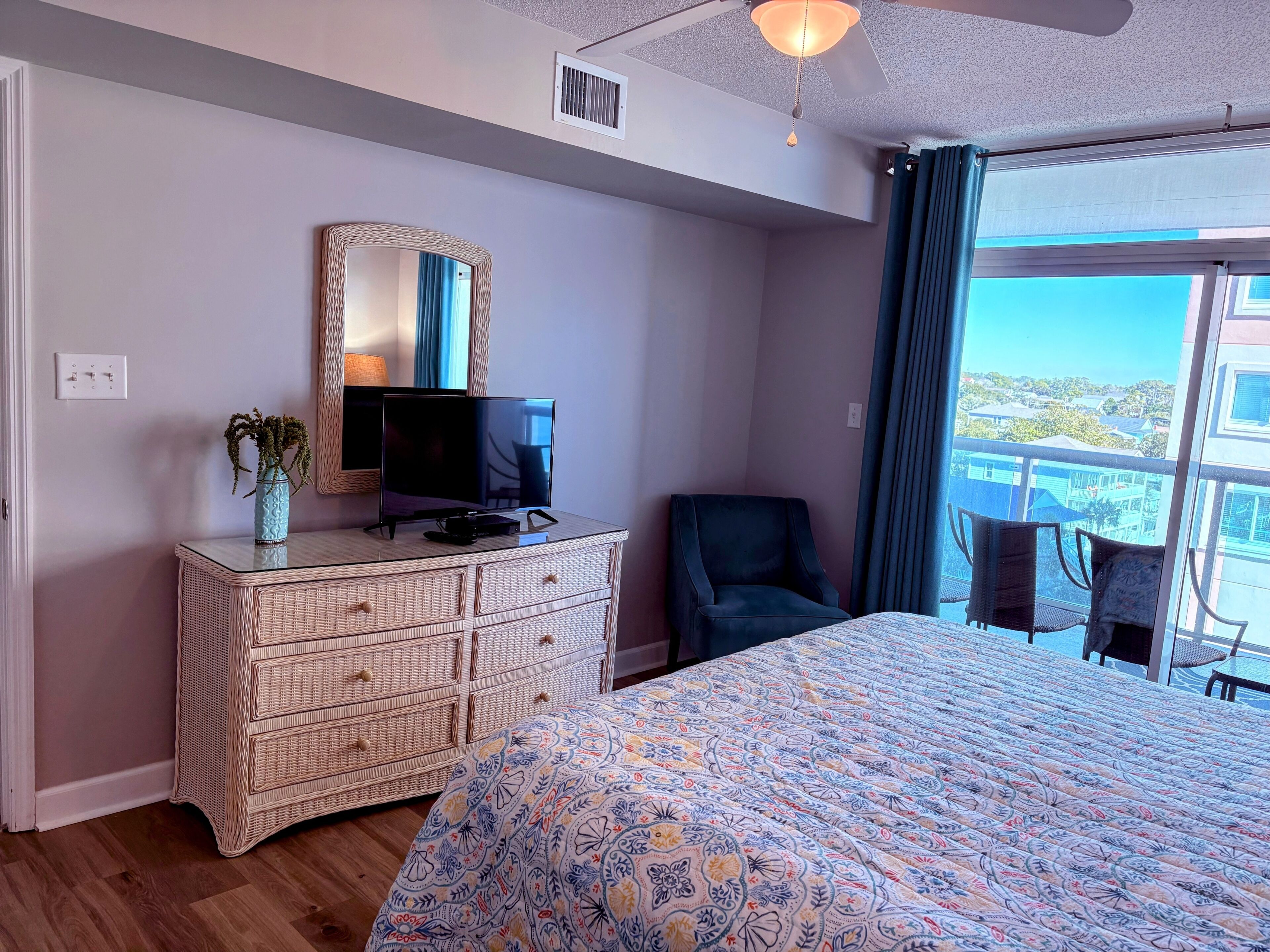 Primary bedroom with ample storage space, chair for reading and TV