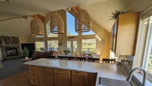 A spacious kitchen with a large island, wooden cabinets, and a built-in sink.
