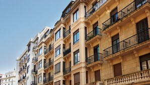 A multi-story building with balconies, large windows, and a classic architectural style. - Moneo by FeelFree Rentals (San Sebastián)