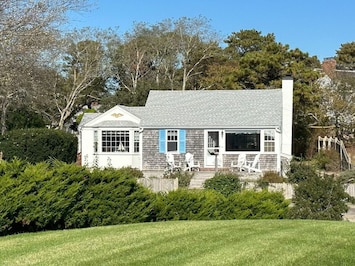The 1 bedroom Sea Breeze Suite to the right with the raised patio perfect for sundowners. The 2 bedroom Dune Suite is the bay window to the left & flows back into the yard. This listing includes both suites; each has its own kitchen, full bath, LR.