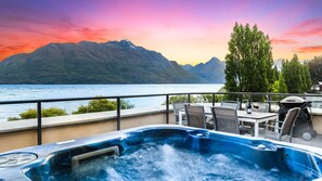 A hot tub on a balcony with a view of a lake and mountains. - Central Luxury at 408 The Beacon | Hot Tub | 2 Bed | 2 Bath (Queenstown)