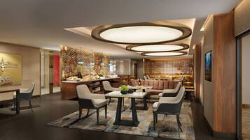 A modern dining area with a central island, seating arrangements, and a decorative ceiling.