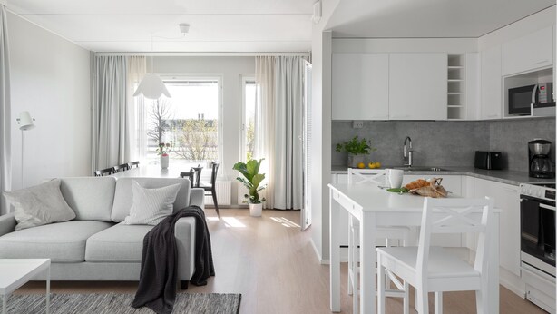 A modern apartment with a living room, dining area, and kitchen. - SleepWell Apartments Katajanokka (Helsinki)