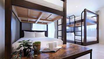 A bunk bed room with a wooden ceiling, a single bed with white bedding, a small table with a mug and a plant, and a window with curtains.