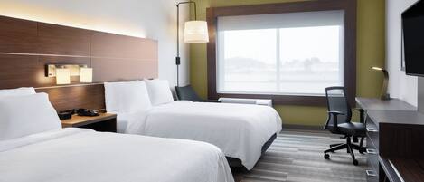 A hotel room with two beds, a desk, a chair, a TV, and a large window.