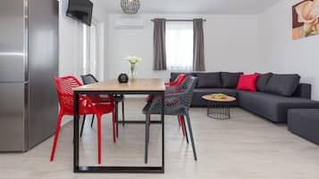 Deluxe Apartment, Sea View | Living area | Flat-screen TV