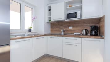 Deluxe Apartment | Private kitchen | Full-size fridge, oven, stovetop, coffee/tea maker