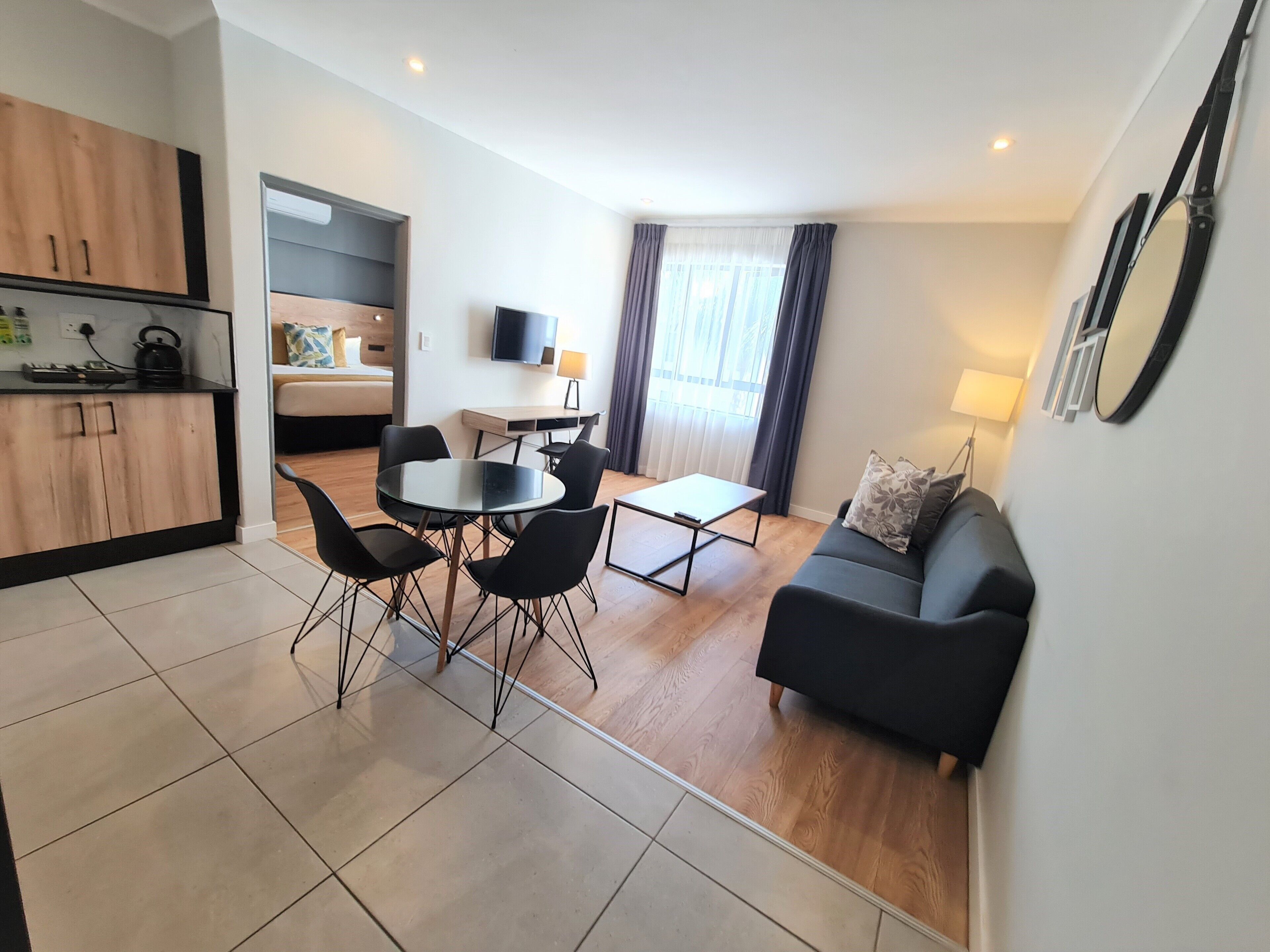 A modern apartment with a kitchen, dining area, and living room.
