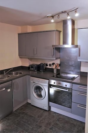 Executive Apartment (West Midlands) | Private kitchen | Full-size fridge, microwave, oven, stovetop
